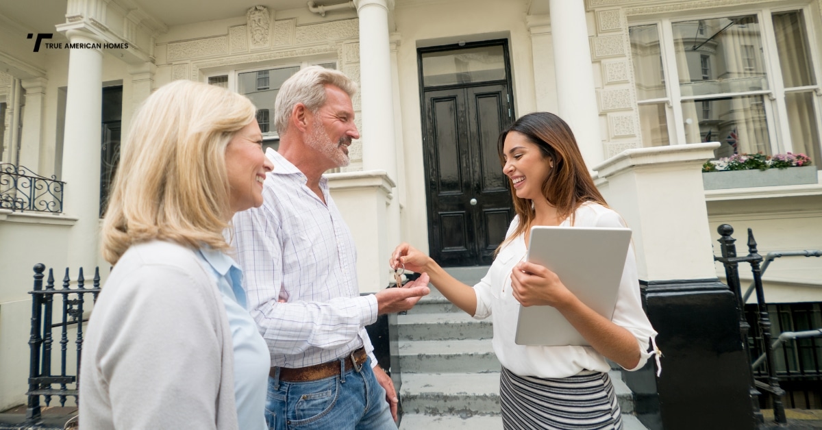 Utah family standing outside an older home looking hopeful