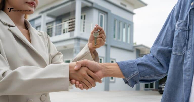 Couple shaking hands with buyer after selling house quickly