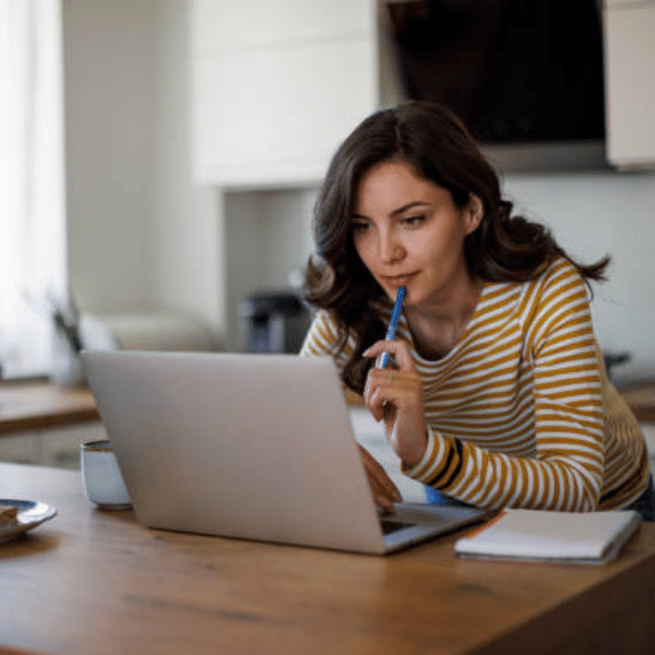 Homeowner checking comparable sales and market data on a laptop