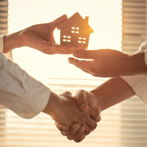 Handshake in front of house representing a cash home deal